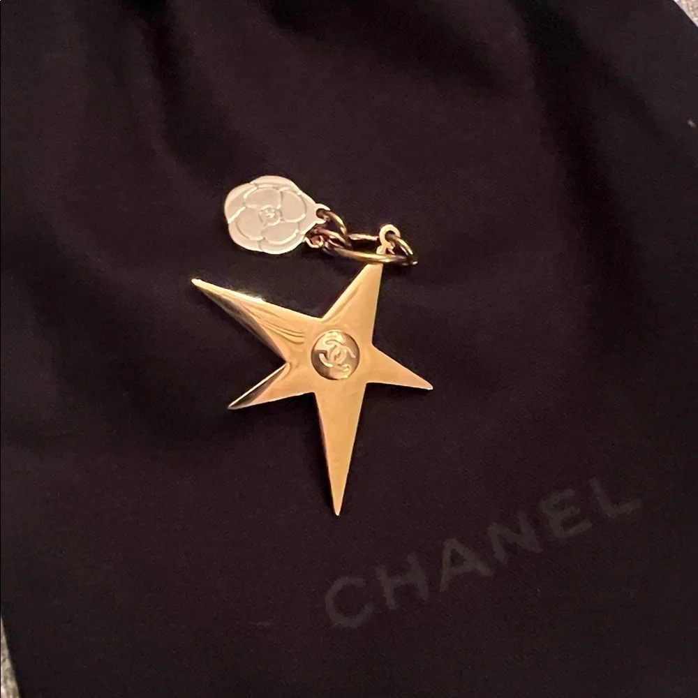 CHANEL Gold Star & small Camellia key Charm with black drawstring pouch.
